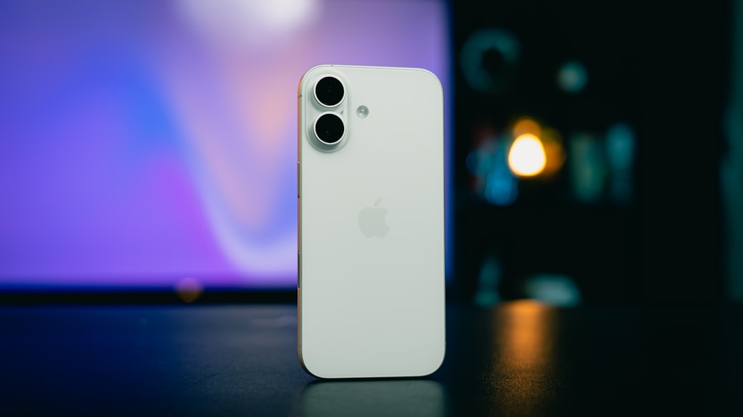 White smartphone with dual camera on table.